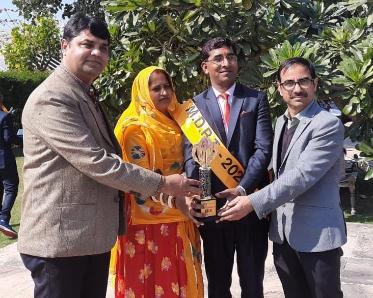 Indian family silhouette walking towards bright sunrise symbolizing secure financial future with best insurance advisor planning in Rajasthan deep blue and gold sky